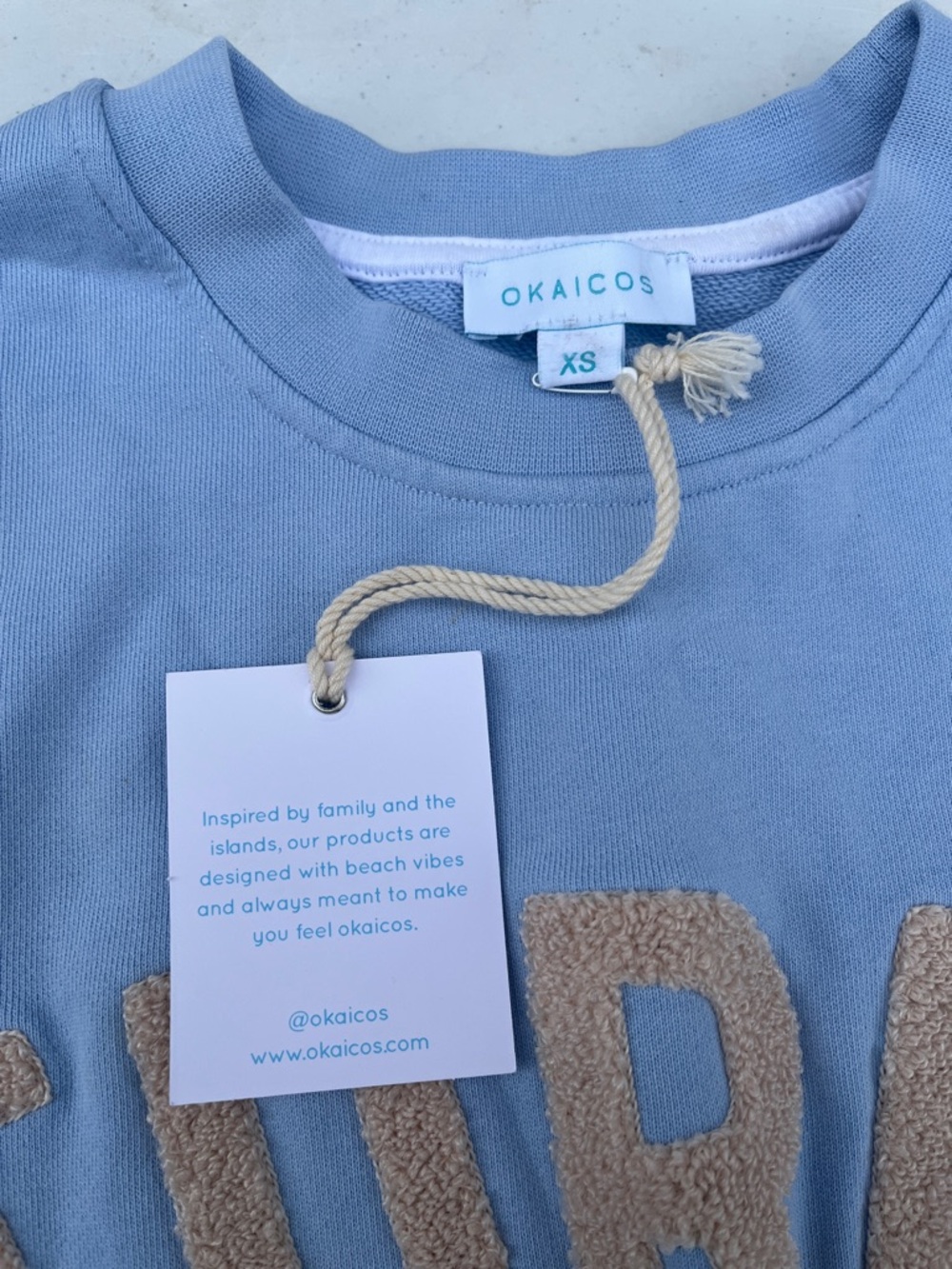 Light Blue Crewneck Sweater with Beige 'TURKS' Chenille Lettering - Picture 3 of 4